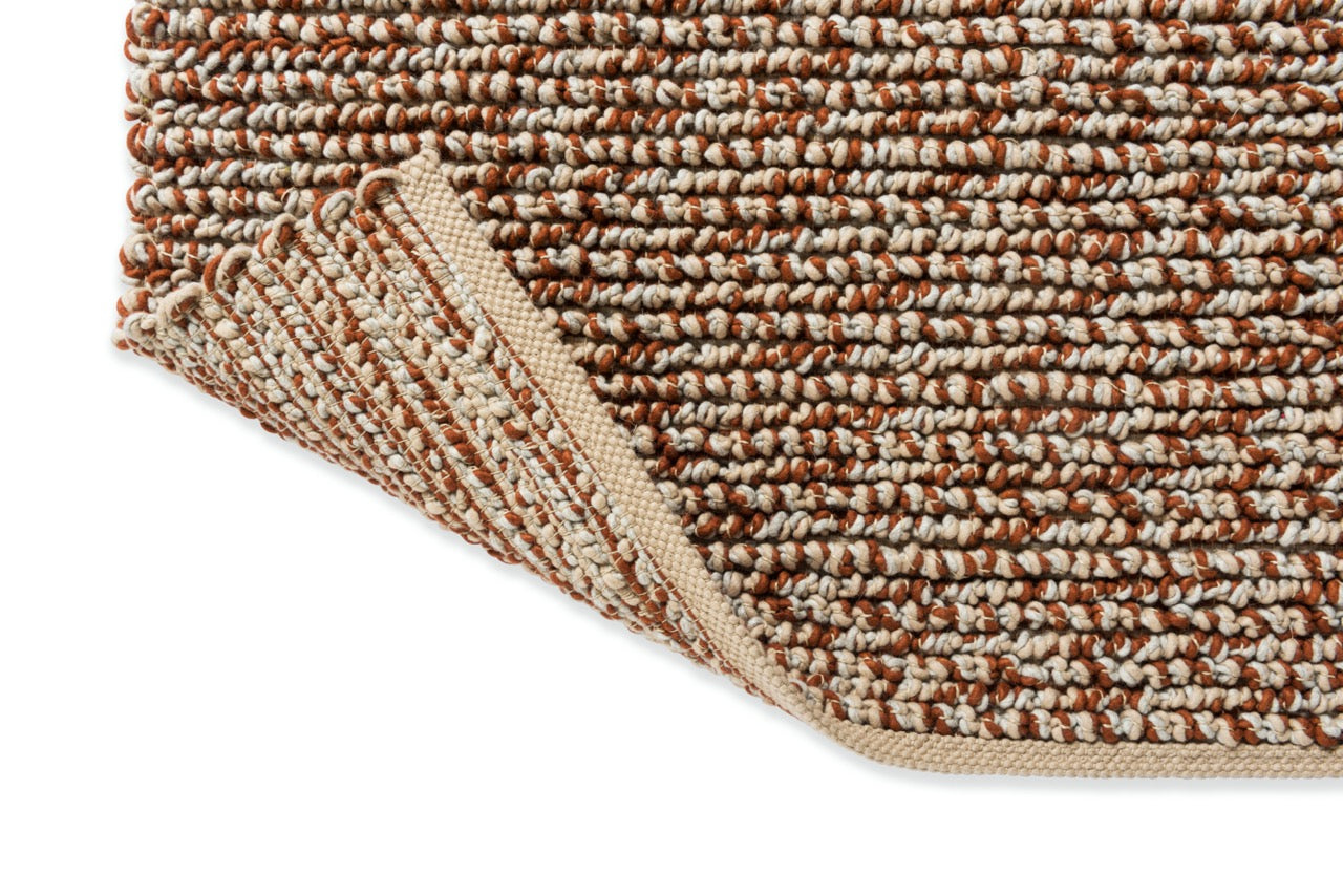 Edge view of the Nest Leather rug highlighting the plush pile and detailed craftsmanship.