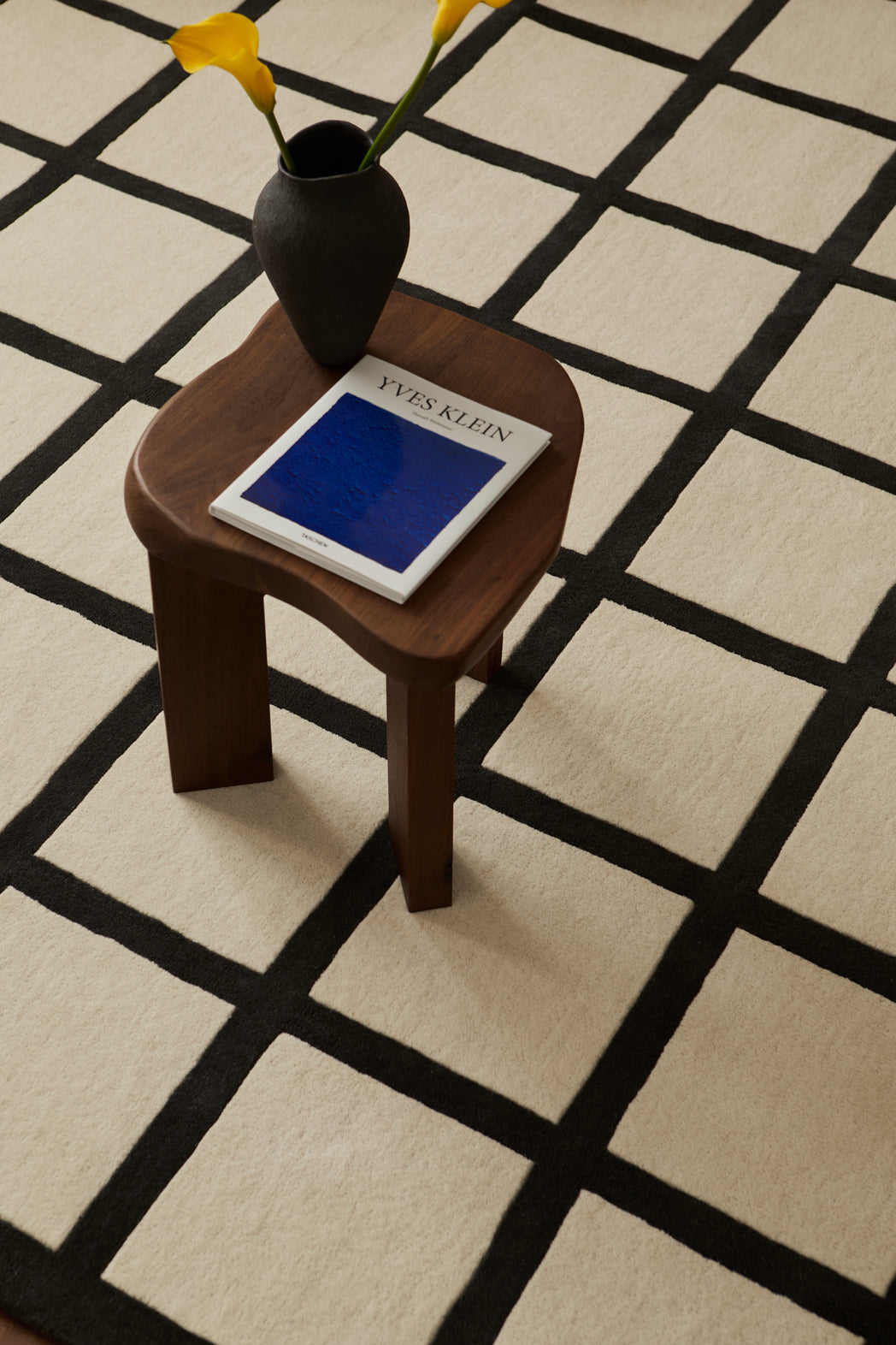Close-up of the handwoven wool texture showcasing the intricate black-and-white check pattern.