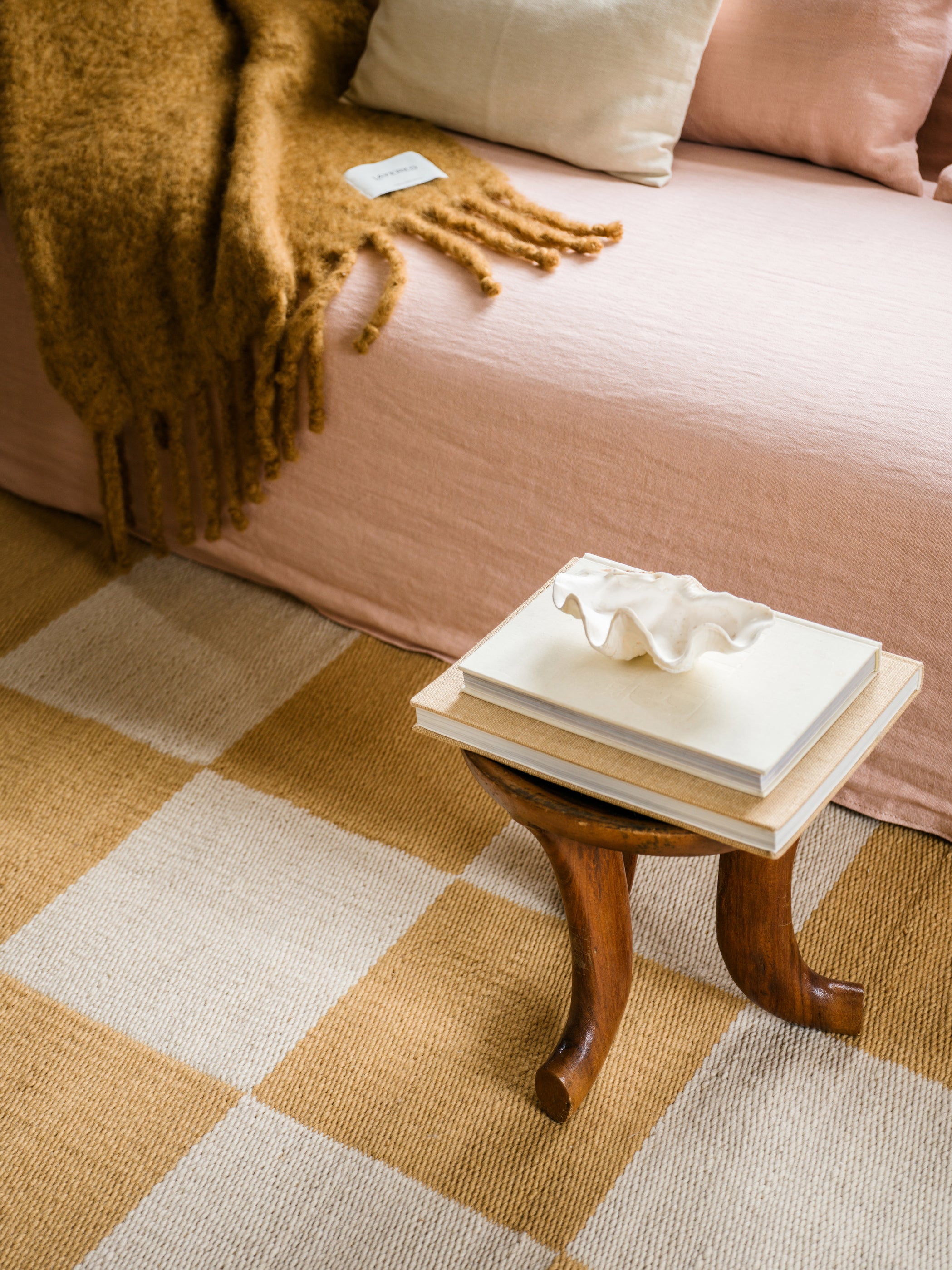 Close-up of handwoven wool texture showing warm ochre and cream checkerboard weave