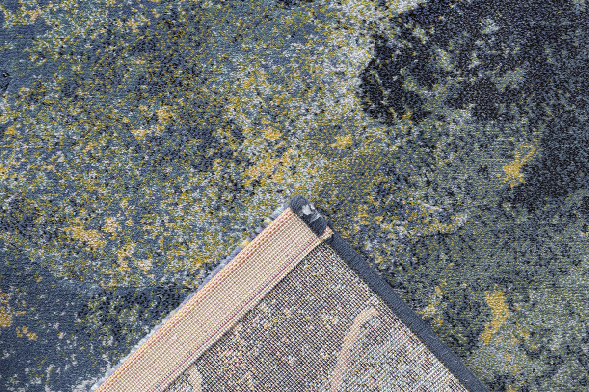 Folded corner showing the woven backing of the Tapison Home Torino 063.0934.5241 blue rug