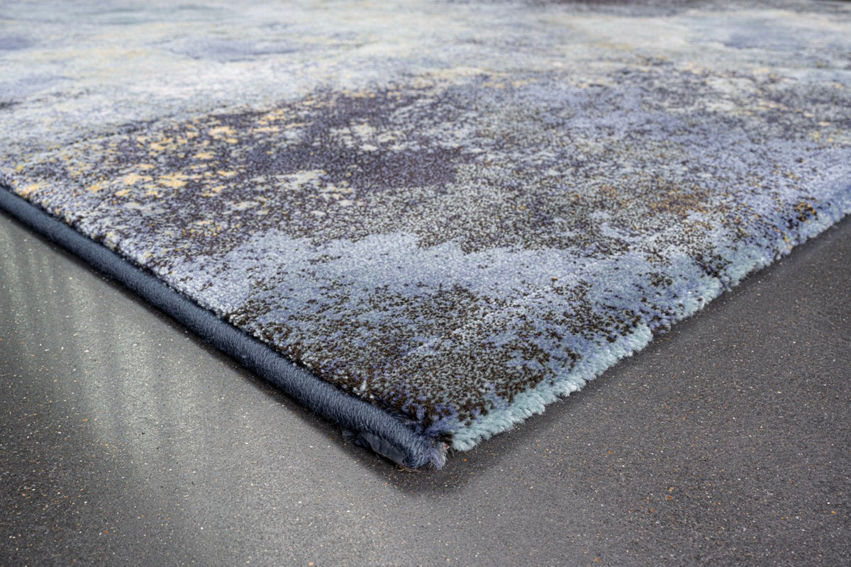 Corner detail of the Tapison Home Torino 063.0934.5241 rug in blue, sage green and ochre