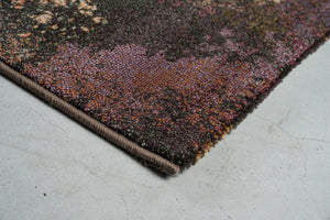 Corner detail of the Tapison Home Torino 063.0934.7274 rug in plum, mauve and olive green