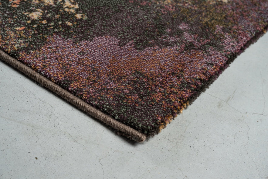 Corner detail of the Tapison Home Torino 063.0934.7274 rug in plum, mauve and olive green