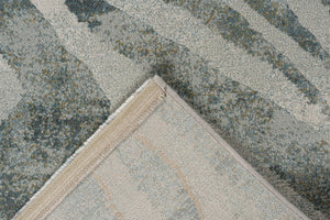 Folded corner showing the woven backing of the Tapison Home Torino 063.0990.4299 green rug