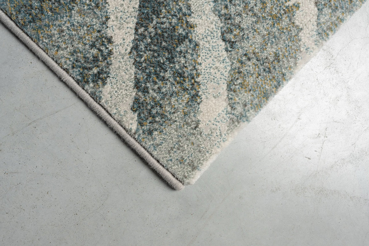 Corner detail of the Tapison Home Torino 063.0990.4299 rug in green and grey
