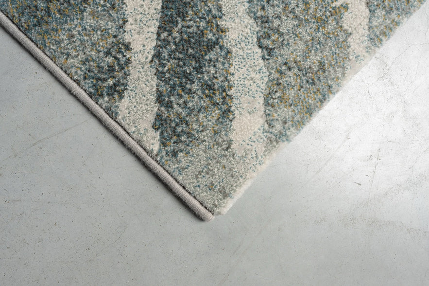 Corner detail of the Tapison Home Torino 063.0990.4299 rug in green and grey