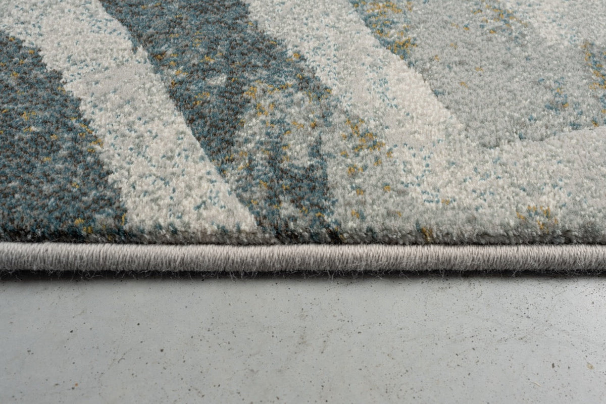 Side view of the low pile and finished edge of the Tapison Home Torino 063.0990.4299 rug