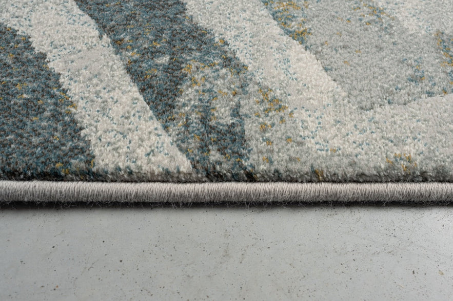 Side view of the low pile and finished edge of the Tapison Home Torino 063.0990.4299 rug