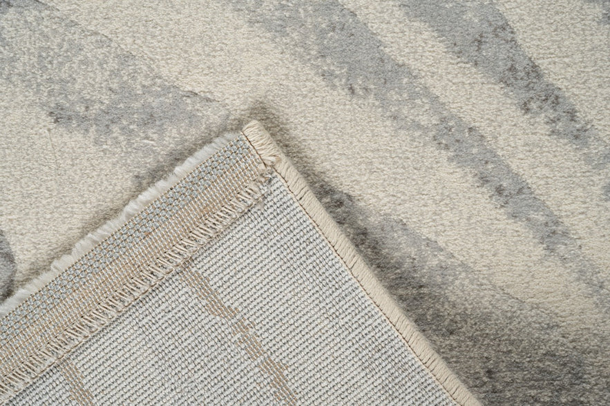 Folded corner showing the woven backing of the Tapison Home Torino 063.0990.6797 ivory rug