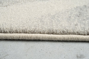 Side view of the low pile and finished edge of the Tapison Home Torino 063.0990.6797 rug