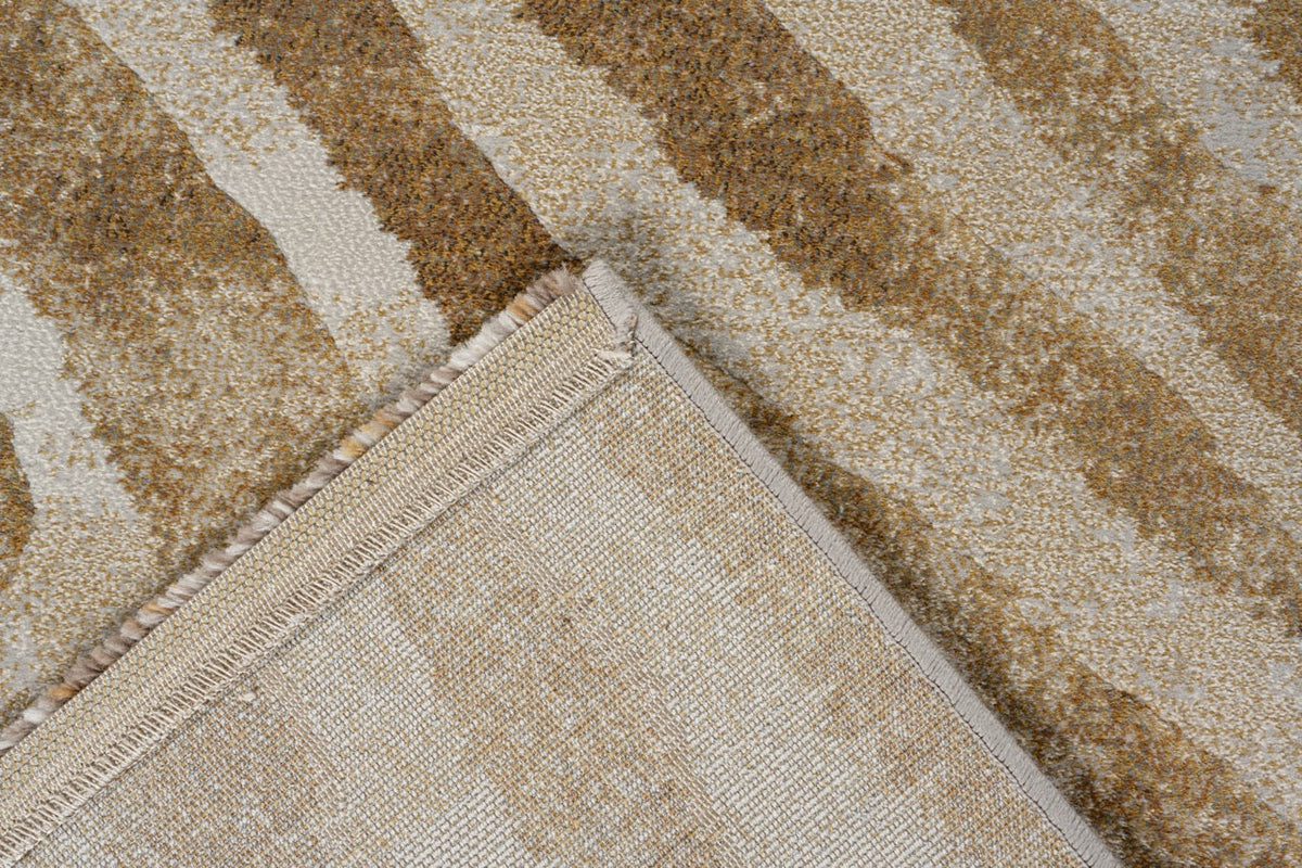 Folded corner showing the woven backing of the Tapison Home Torino 063.0990.7299 ochre rug