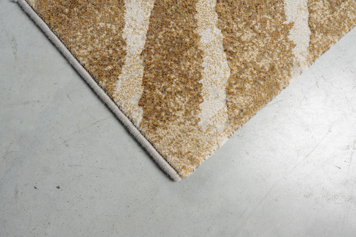 Corner detail of the Tapison Home Torino 063.0990.7299 rug in ochre and ivory