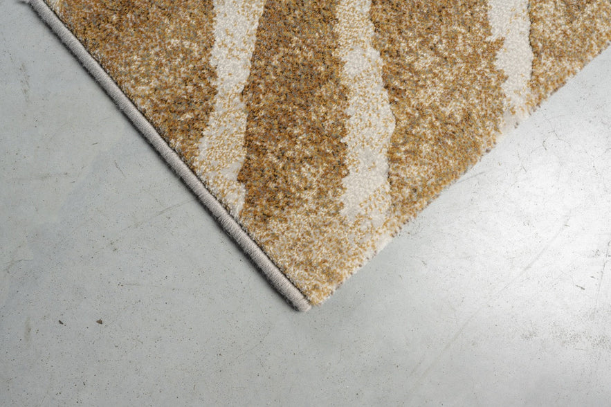 Corner detail of the Tapison Home Torino 063.0990.7299 rug in ochre and ivory