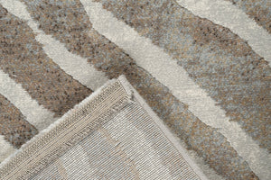 Folded corner showing the woven backing of the Tapison Home Torino 063.0990.9243 taupe rug