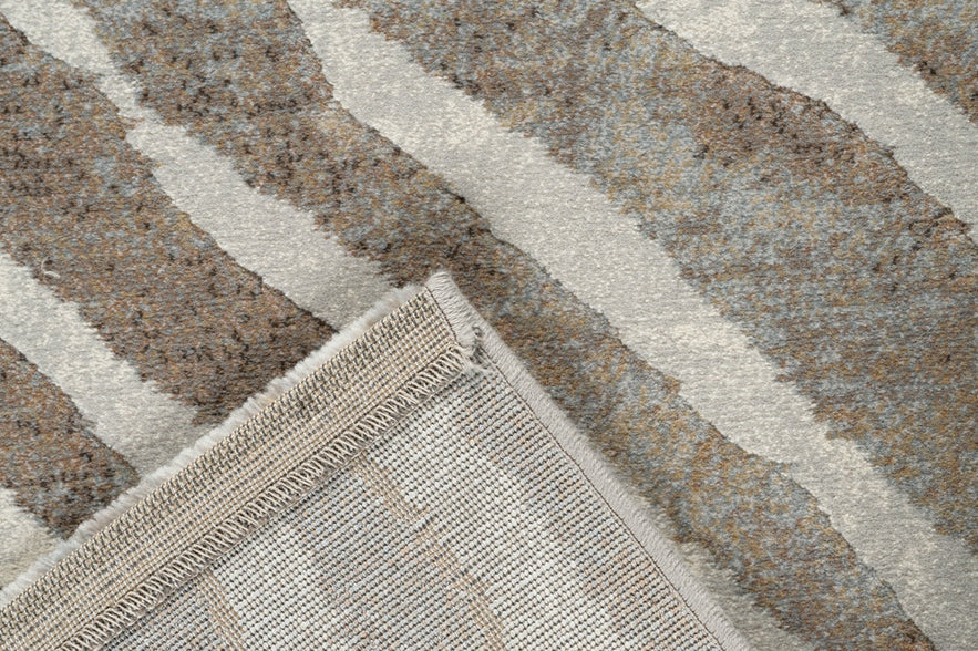 Folded corner showing the woven backing of the Tapison Home Torino 063.0990.9243 taupe rug