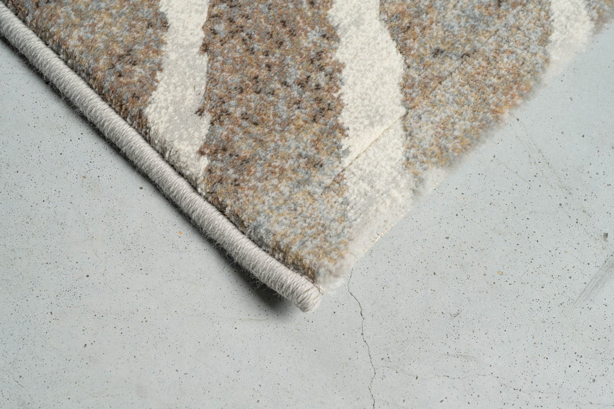 Corner detail of the Tapison Home Torino 063.0990.9243 rug in taupe and ivory