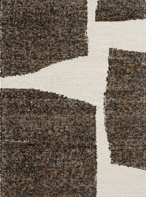 Full top-down view of geometric wool rug in cream and chocolate earth tones