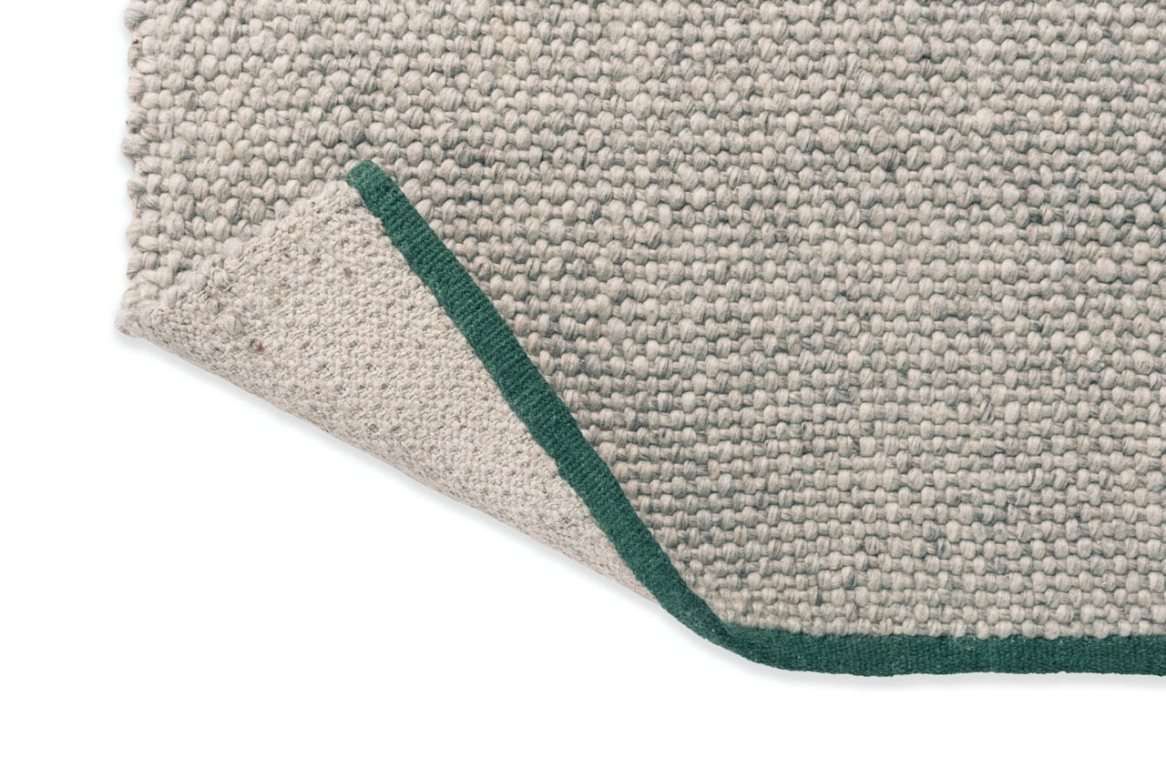 Corner close-up of the Craft Matter rug with matte wool finish 