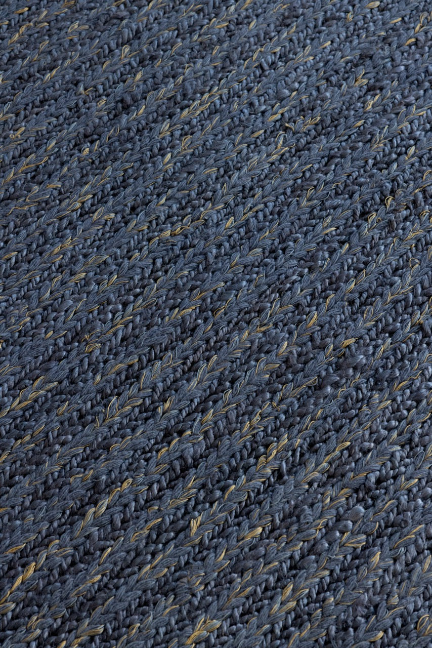 Close-up of braided denim wool texture in handwoven flatweave rug