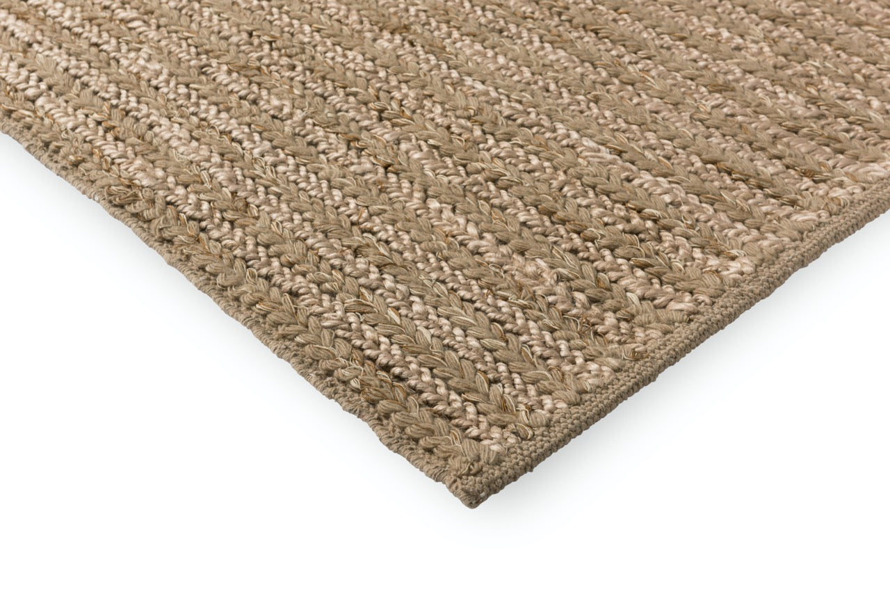 Corner view showing structured weave and soft pile edge on wood flooring