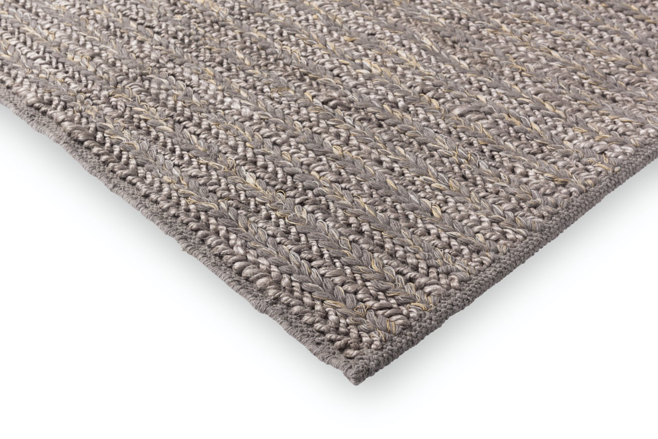 Edge view showing pile height and structure of wool rug 
