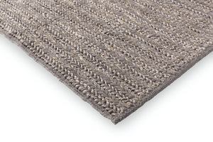 Edge view showing pile height and structure of wool rug 