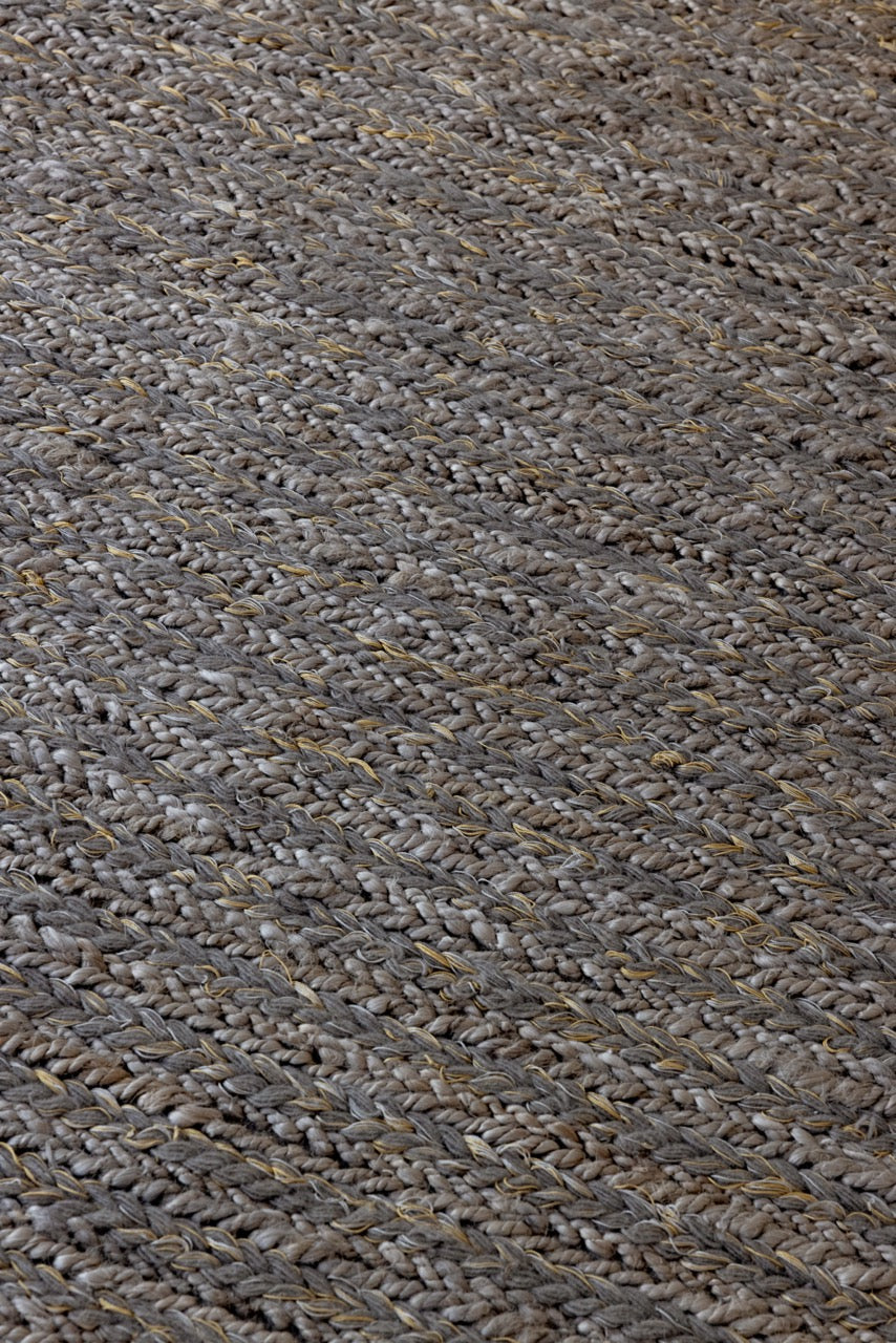 Close-up of braided wool texture in handwoven stone flatweave rug