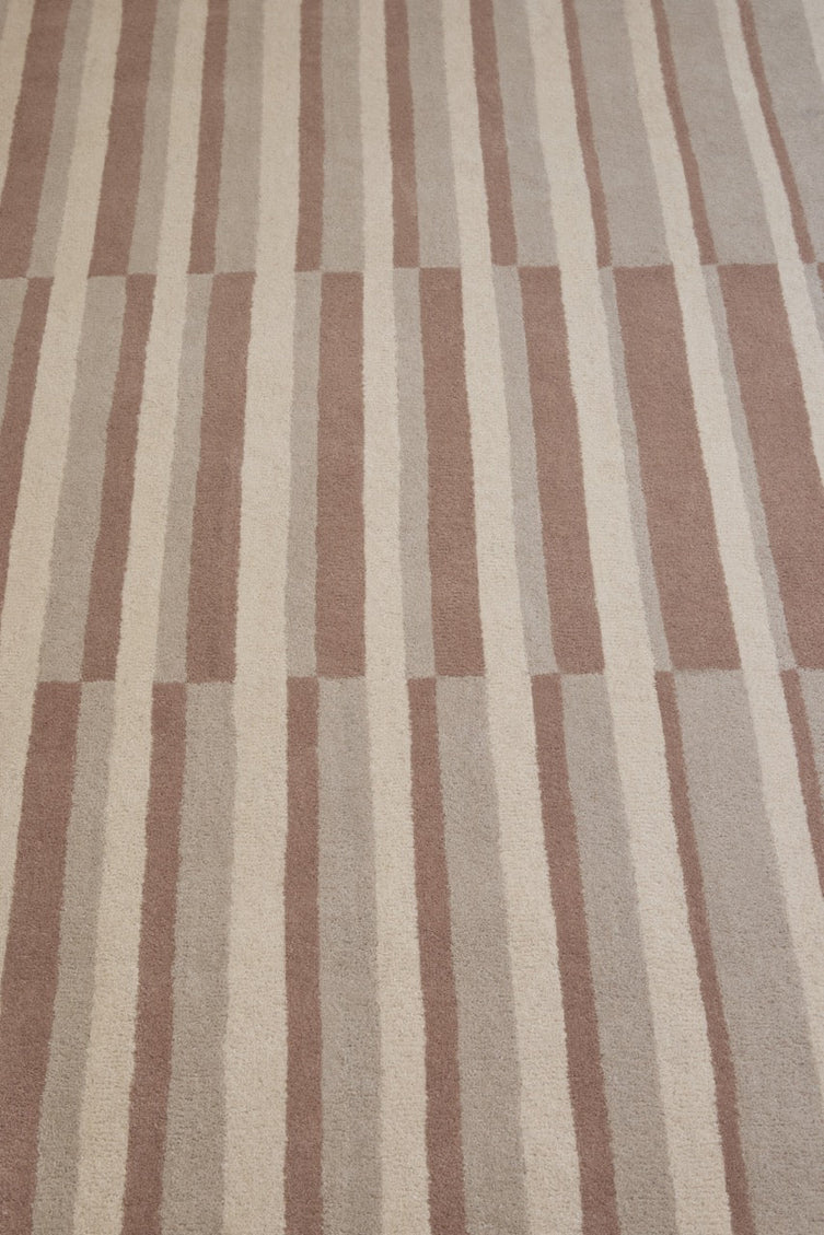 Brink & Campman Decor Pilar Blush rug in dusty pink with cream and greige stripes, shown in an interior, third view