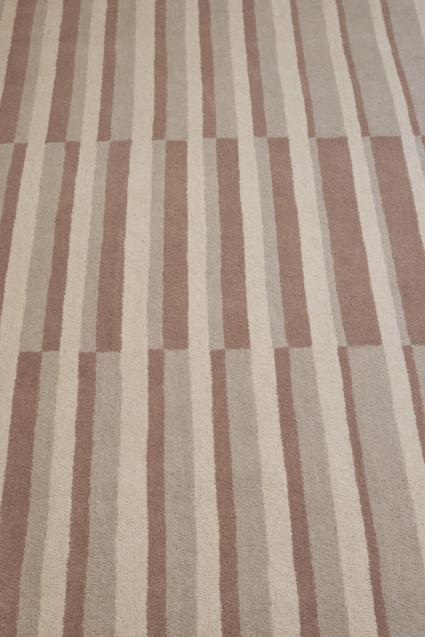 Brink & Campman Decor Pilar Blush rug in dusty pink with cream and greige stripes, shown in an interior, third view