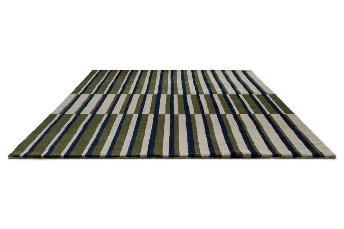 Brink & Campman Decor Pilar Moss rug in moss green with navy blue and light grey stripes, perspective view