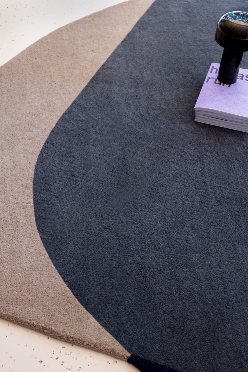 Brink & Campman geometric rug layered with neutral-toned seating