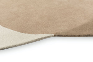 Close-up of carved relief on hand-tufted wool rug in ivory and stone