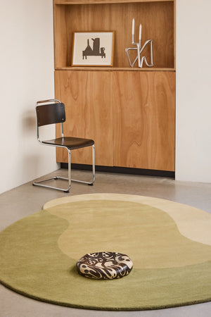 Brink & Campman Element Lane Green rug in olive green, ochre yellow and cream, shown in an interior