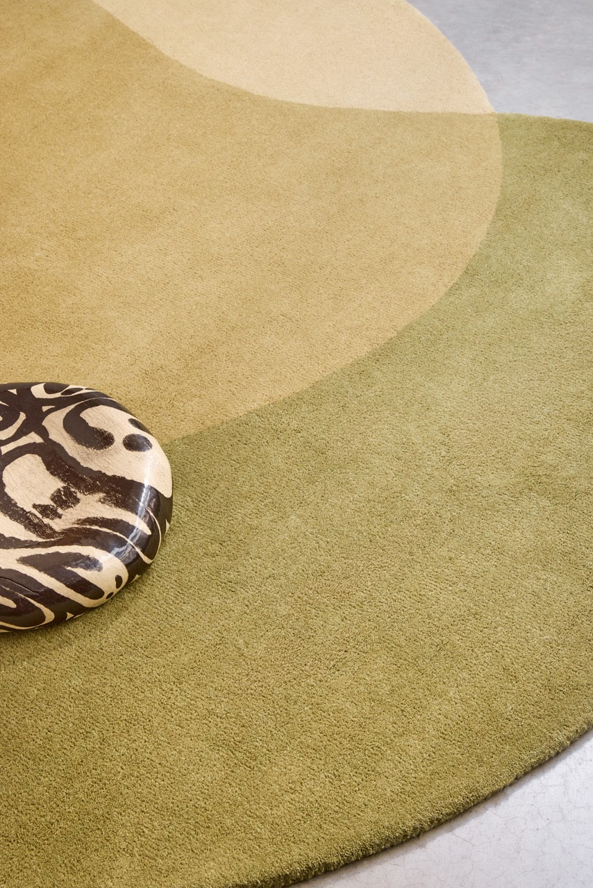 Brink & Campman Element Lane Green rug in olive green, ochre yellow and cream, shown in an interior, second view