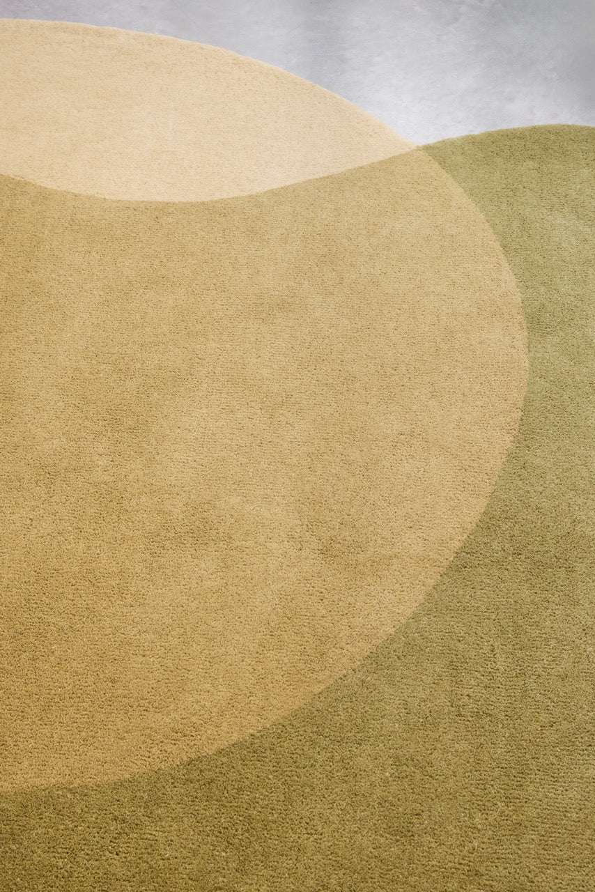 Brink & Campman Element Lane Green rug in olive green, ochre yellow and cream, shown in an interior, third view