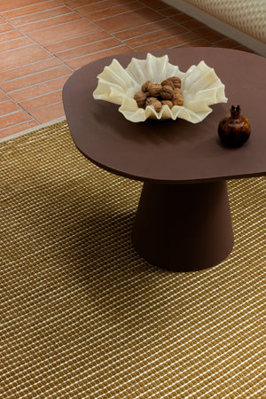 Close-up of raised mustard wool pile with carved central field