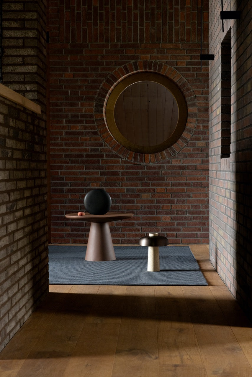 Brink & Campman Grid Slate rug styled in a minimal living space with concrete and wood accents