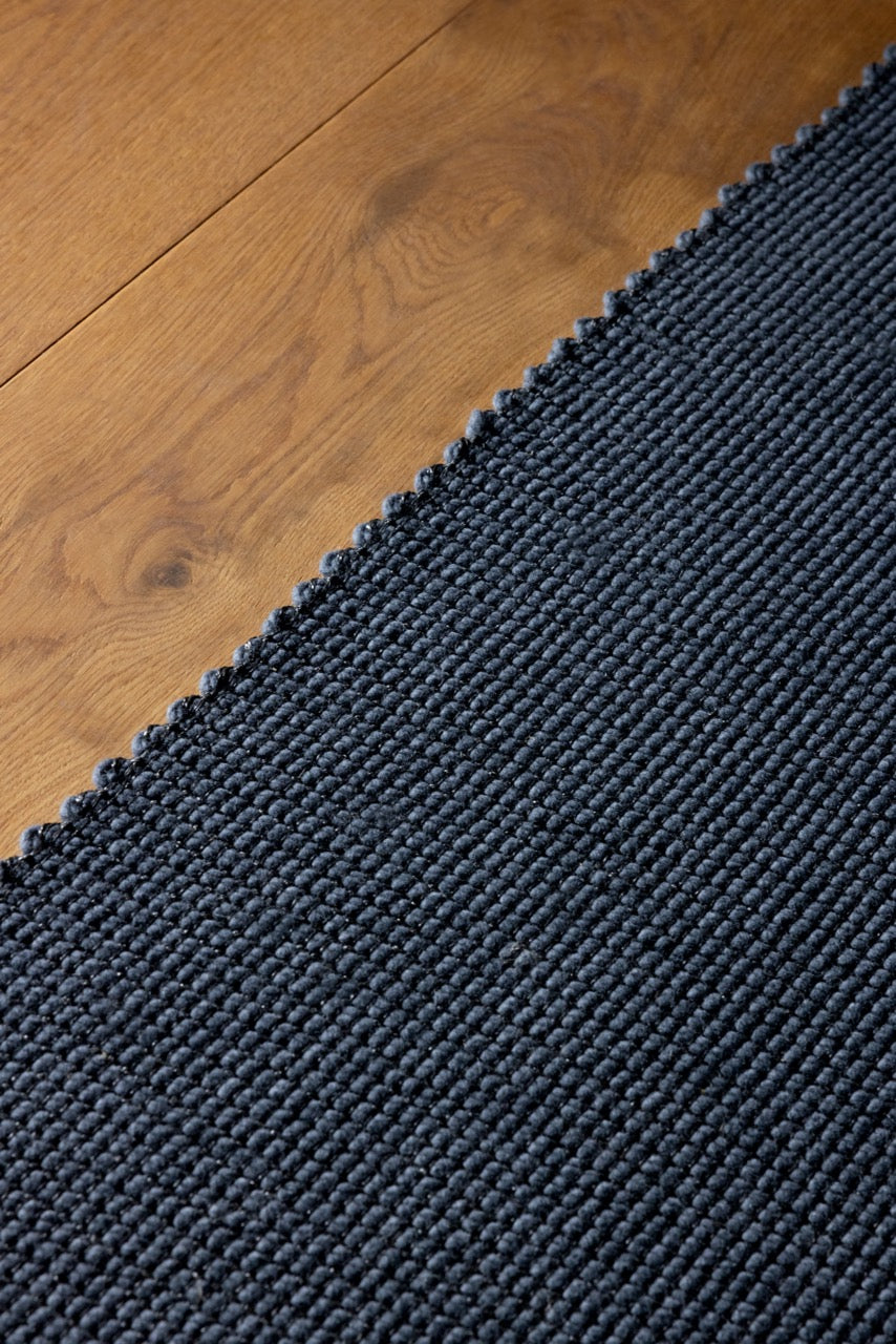 Close-up of handwoven grid texture in slate grey wool and jute blend

