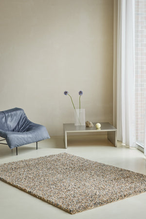 Brink & Campman Loom Natural rug in beige and cream with grey and charcoal flecks, shown in an interior