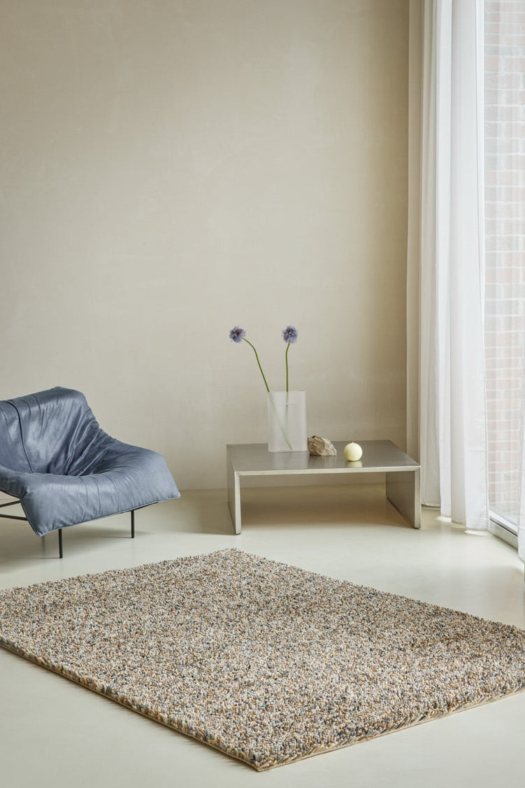 Brink & Campman Loom Natural rug in beige and cream with grey and charcoal flecks, shown in an interior