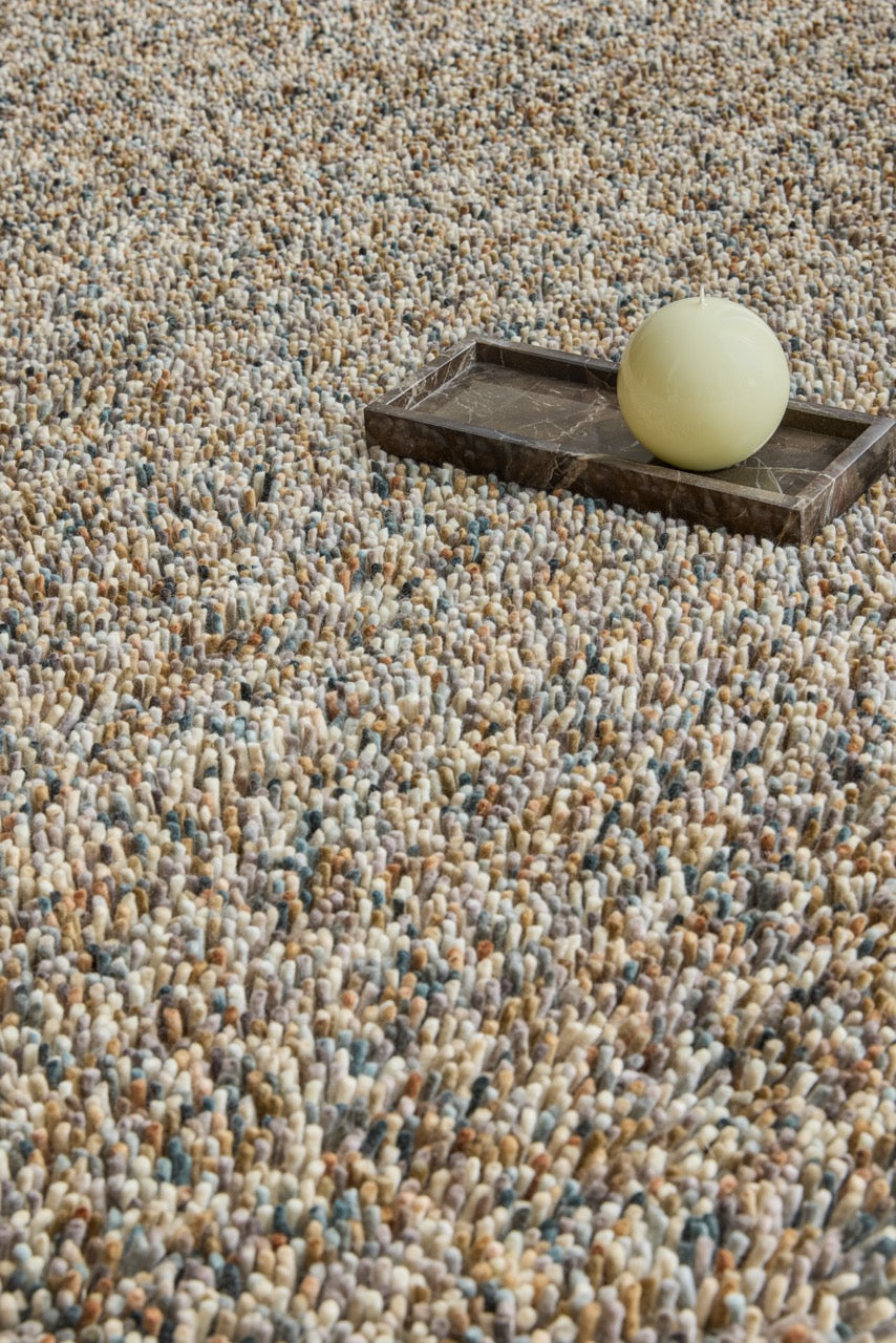 Brink & Campman Loom Natural rug in beige and cream with grey and charcoal flecks, shown in an interior, second view