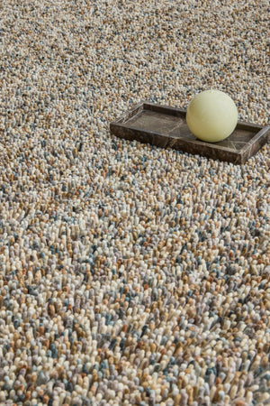 Brink & Campman Loom Natural rug in beige and cream with grey and charcoal flecks, shown in an interior, second view