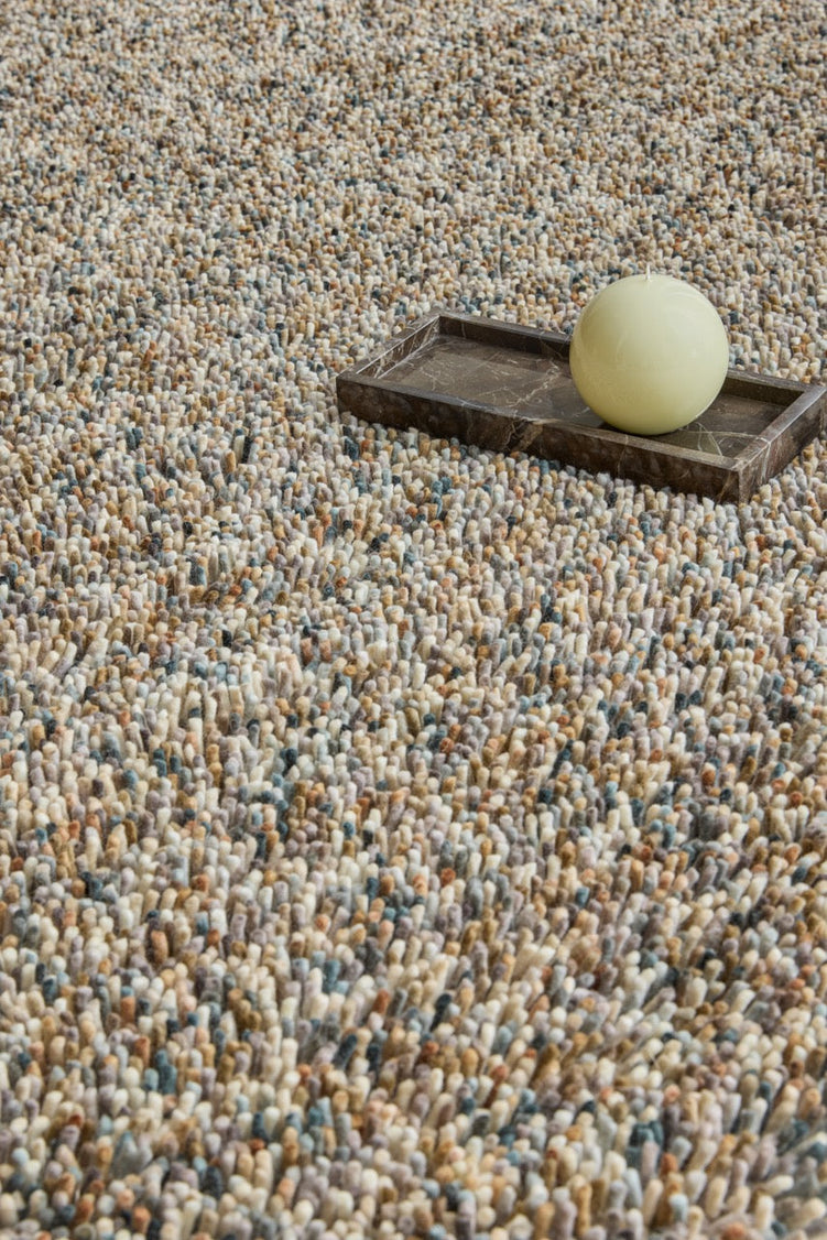 Brink & Campman Loom Natural rug in beige and cream with grey and charcoal flecks, shown in an interior, second view
