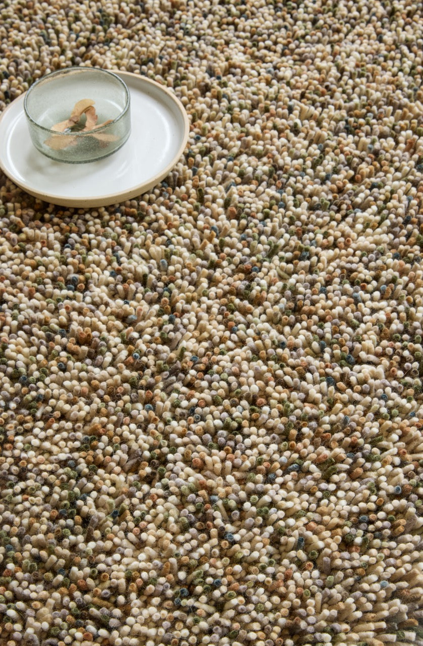 Brink & Campman Loom Natural Moss rug in beige and cream with moss green and brown flecks, shown in an interior, second view