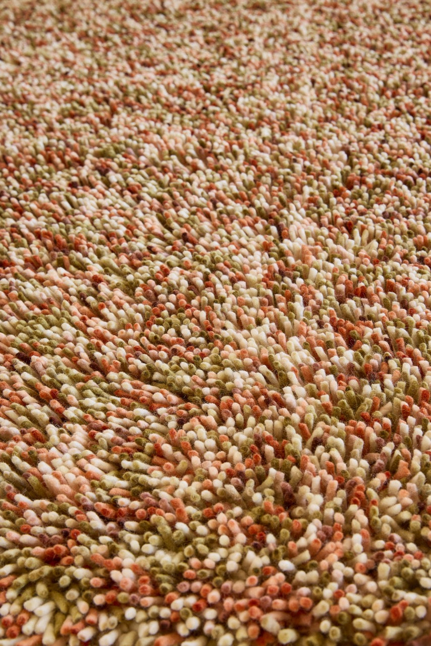 Brink & Campman Loom Pumpkin rug in pumpkin orange, coral and olive green, shown in an interior, third view