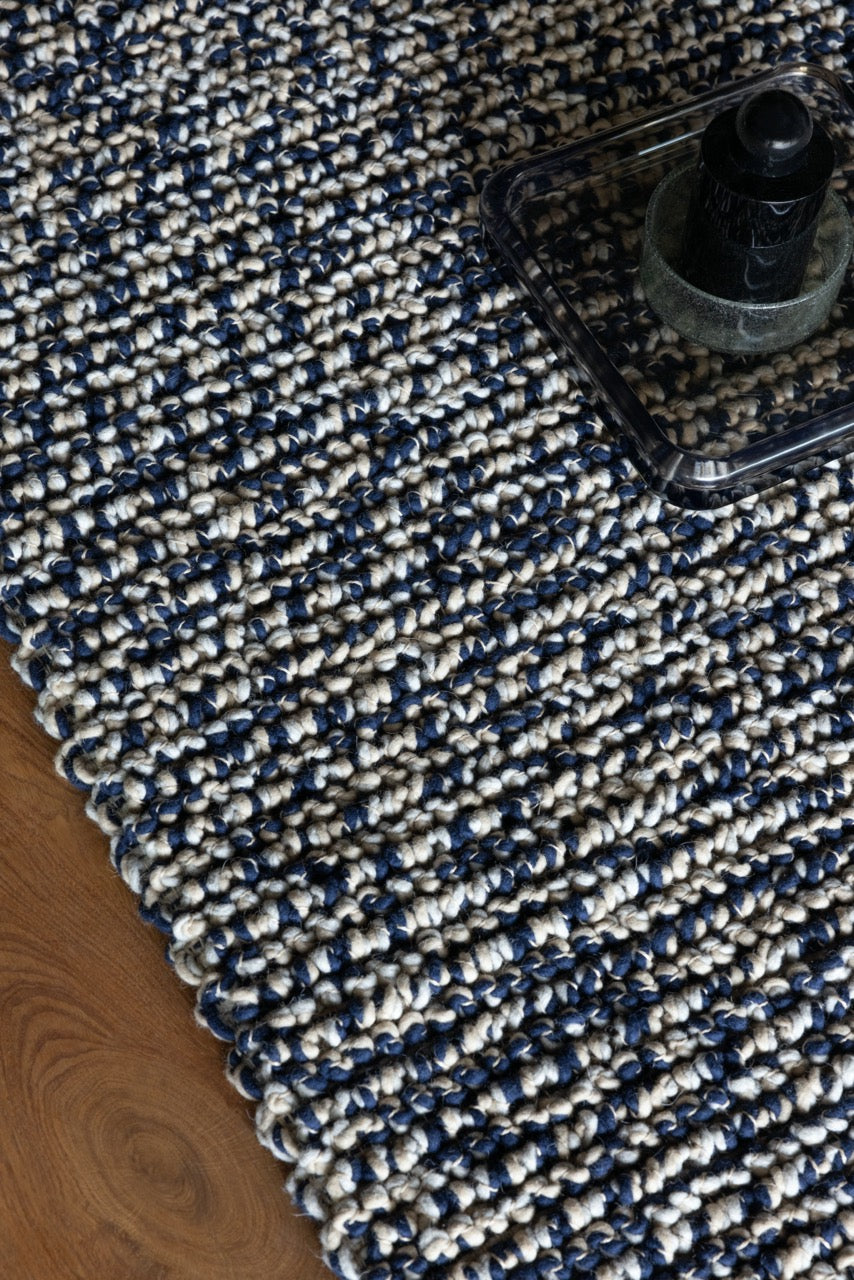 Close-up of deep blue wool loops with rich handwoven texture

