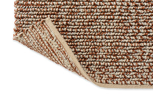 Edge view of the Nest Leather rug highlighting the plush pile and detailed craftsmanship.