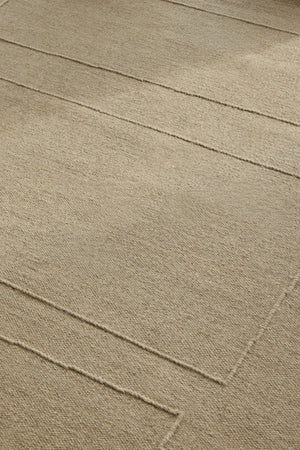 Brink & Campman Senso Blocks Natural rug in sand beige with three blocks in relief, shown in an interior, second view