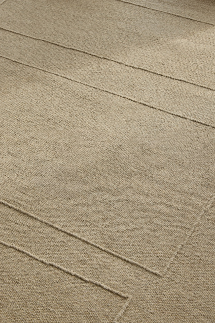 Brink & Campman Senso Blocks Natural rug in sand beige with three blocks in relief, shown in an interior, second view