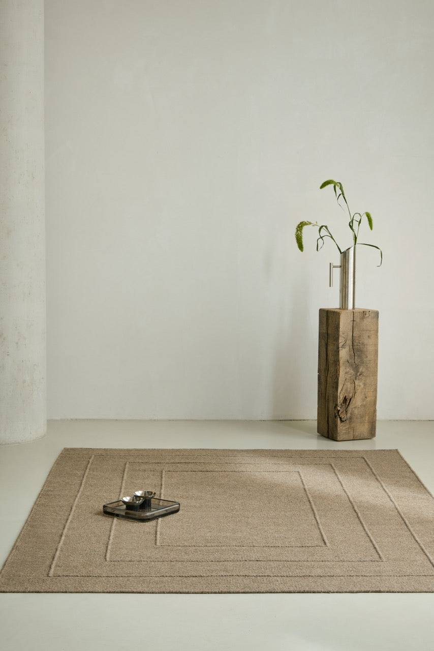 Brink & Campman Senso Border Fur Brown rug in camel brown with three frames in relief, shown in an interior